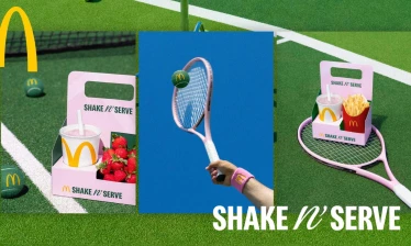 McDonald's Shake n' Serve box meals with strawberries, branded tennis balls, and pink tennis rackets taken on grass tennis court.