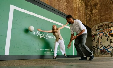 Two football fans playing street football by the Carlsberg OOH activation