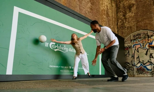 Two football fans playing street football by the Carlsberg OOH activation