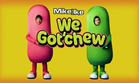 Mike and Ike brand characters holding up title: "We Got'chew" against a burnt yellow background.