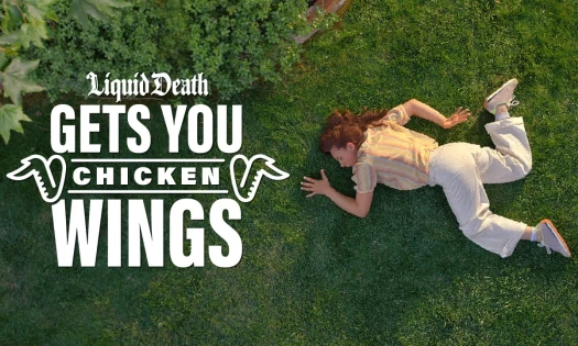 A woman lying down on grass like a chicken wing
