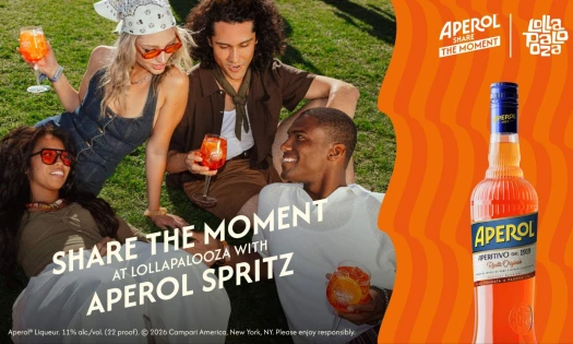 A group of friends sitting on grass with Aperol Spritz, a bottle of Aperol is on the right with the Lollapalooza logo in the top right corner.