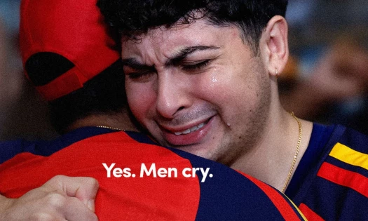 Two men embracing and crying with the caption: "Yes. Men cry."