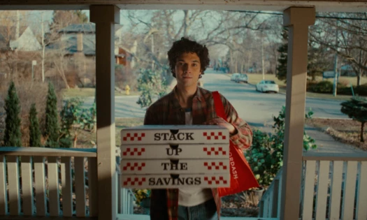 A DoorDash delivery man standing by the door