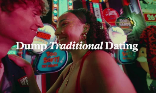 A young couple in an arcade with "Dump Traditional Dating" overlayed in the center