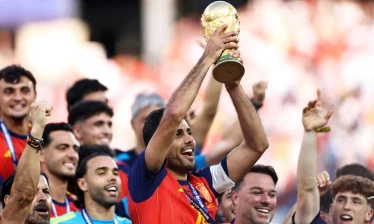 Spain captain Rodri holds up 2026 FIFA World Cup trophy during victory celebration