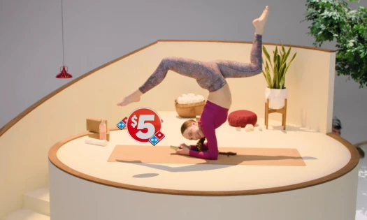 A woman holding a pose while ordering from her Domino's app
