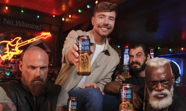 MrBeast holding up the new Liquid Death flavor as he's surrounded by a biker gang