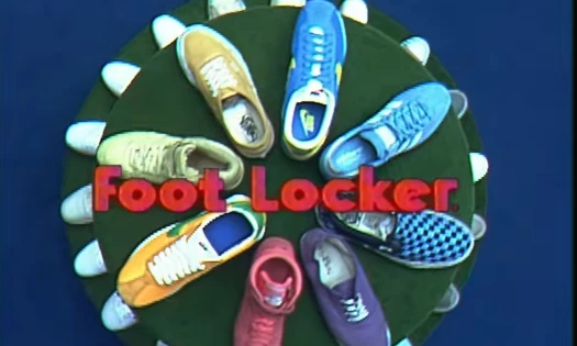 Top view of a spiral display with different iconic sneakers and Foot Locker. red type overlaid.