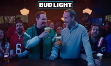 Peyton Manning and Shanne Gills sharing a toast of Bud Light