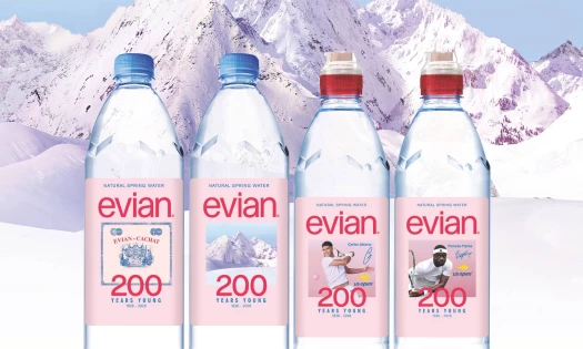 evian water bottle 200 Years Young packaging with nods to its French Alpine roots and elite tennis.