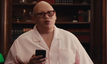 Jacob Batalon holding up his phone as the CEO of Cringemart
