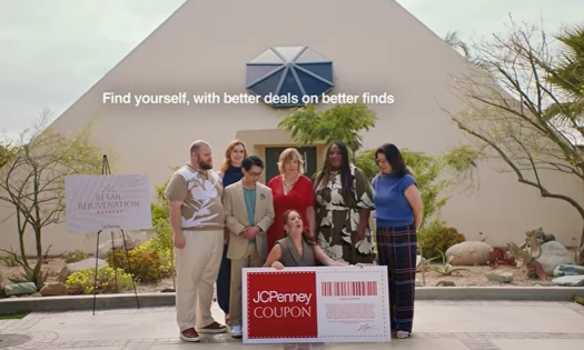 Group photo outside the Retail Rejuvenation Retreat, one person holds up a JCPenney Coupon, while the others surround them.