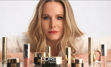 Kristen Bell with an assortment of L'Oréal Paris skin care products.