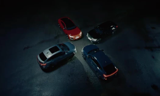 Audi's GT, Q4, A6, and Q6 e-trons on a dark, empty parking lot