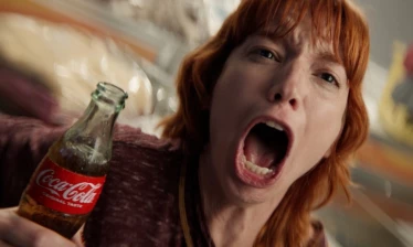A screaming woman holding a Coca-Cola bottle