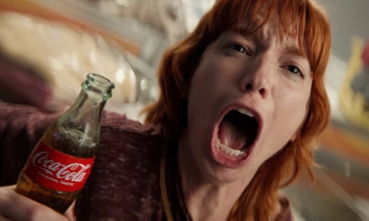 A screaming woman holding a Coca-Cola bottle