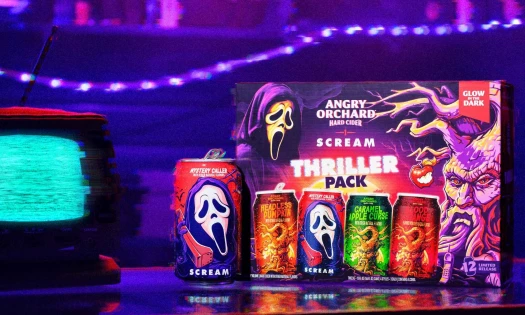 The Angry Orchard x Scream Thriller Variety Pack with Ghost Face packaging and a small box tv to the left.