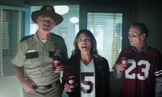 Three people holding a can of Dr Pepper