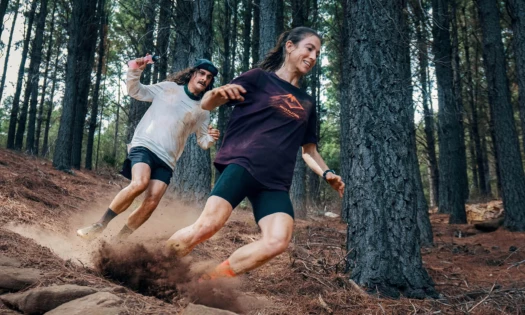 Two women running down a slope