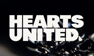 Hearts United logo on a black liquid background.