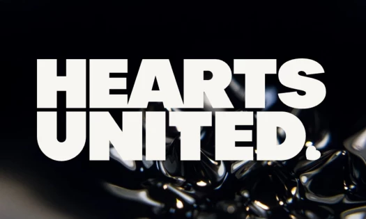 Hearts United logo on a black liquid background.