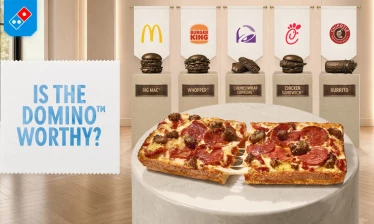 A family eating Domino's in their living room