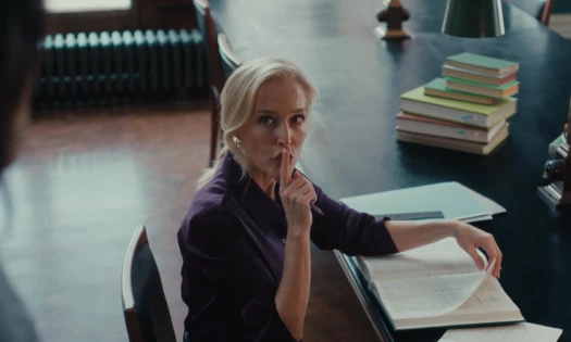 Gillian Anderson signaling someone to hush