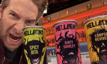 Seth Green with a can of each Hellbent Cocktails' flavors.