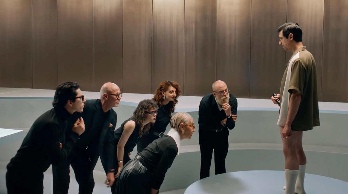 A group of top Italian car designers looking intently at a man using his ball trimmer