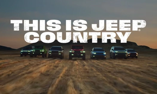 Seven Jeep models in the desert at dusk with "This is Jeep Country" headline in white.