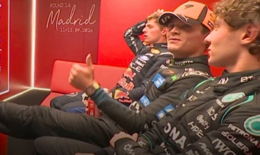 Max Verstappen, Lando Norris, and Kimi Antonelli in the F1 cooldown room with Norris holding a Coca-Cola can.