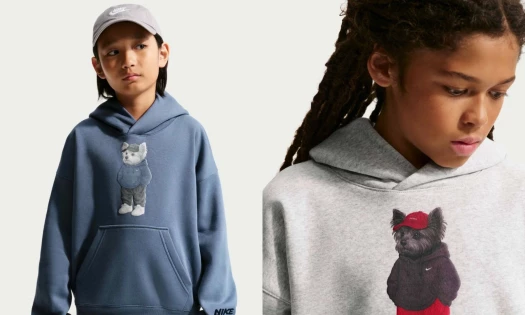 Child models wearing the Nike "Just a Chill Dog" hoodie in Heather Grey and muted Diffused Blue colorways