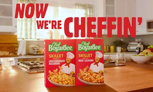 Two Chef Boyardee Skillet Meals on a kitchen counter with the words: "Now We're Cheffin'" above it.