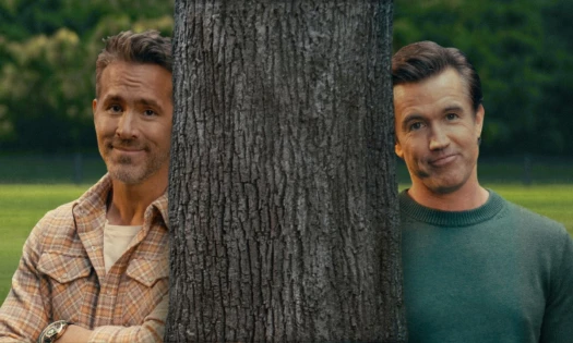 Ryan Reynolds and Rob Mac behind a tree