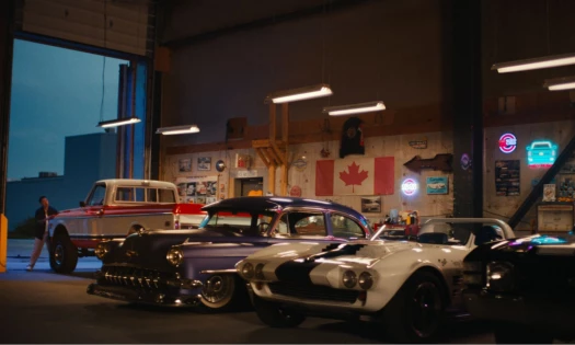 Vintage Chevy cars lined up inside a garage