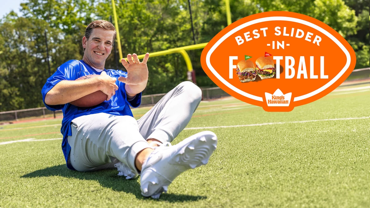 Eli Manning in the pitch with a football