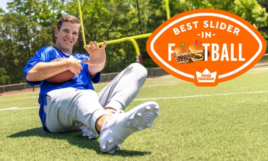Eli Manning in the pitch with a football