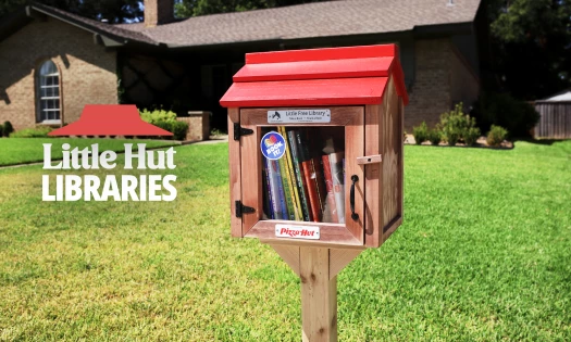 Pizza Hut's "little hut libraries" situated in a front lawn