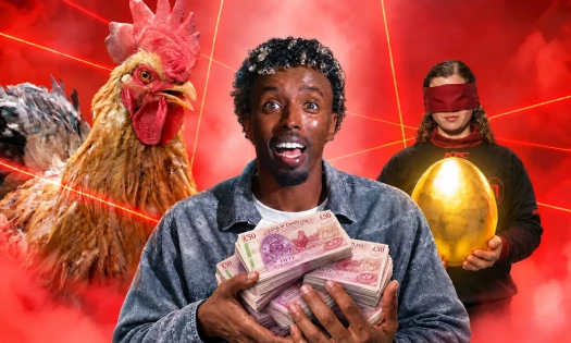 AJ Shabeel holding up cash as a chicken and a blinded contestant stand behind him