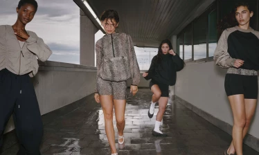 Zendaya walking along a hallway with her enemies