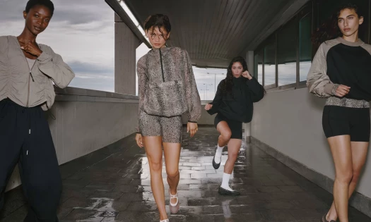 Zendaya walking along a hallway with her enemies