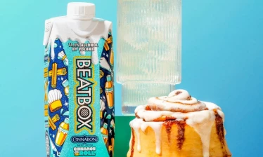 BeatBox Cinnamon Roll alongside a classic Cinnabon and a drink on a blu background.
