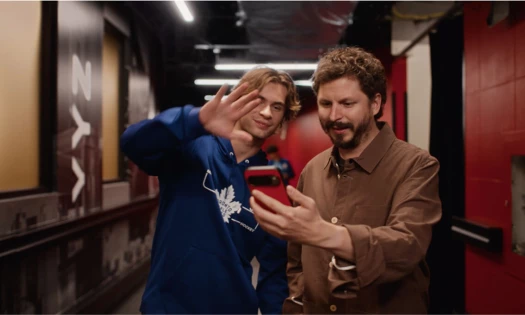 Michael Cera holding up his phone with one of the Backstreet Boys