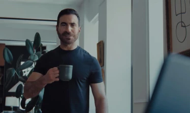 Brett Goldstein holding a cup of coffee