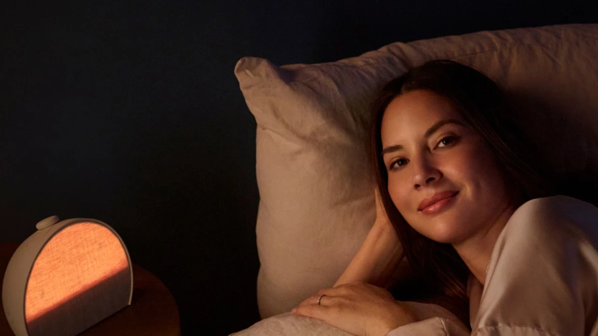 Olivia Munn lying beside her Hatch Sleep Clock