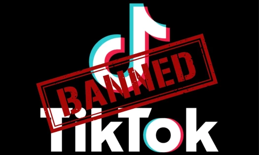 TikTok logo with a banned label painted across it.