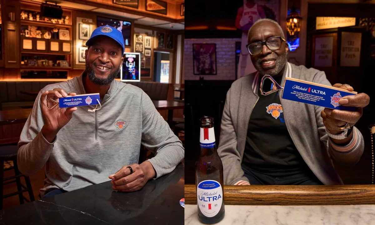 John Wallace and Earl Monroe holding up a Michelob ULTRA Knicks bottle opener