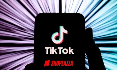 A hand holding a phone with the TikTok and Shoplazza logo on the screen.