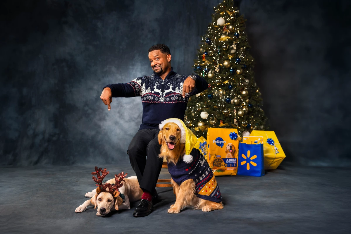 Alfonso Ribeiro with his dogs and Pedigree products behind him